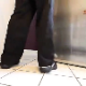 A woman walks into a kitchen, opens the refrigerator door, and then sqats down on a tile floor to take a massive, heaping shit. Exactly 2 minutes.